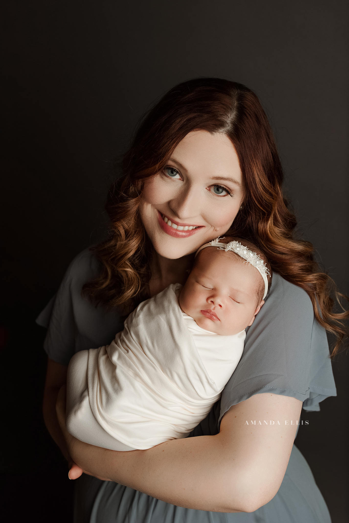 newborn photo with mom wearing a blue dress