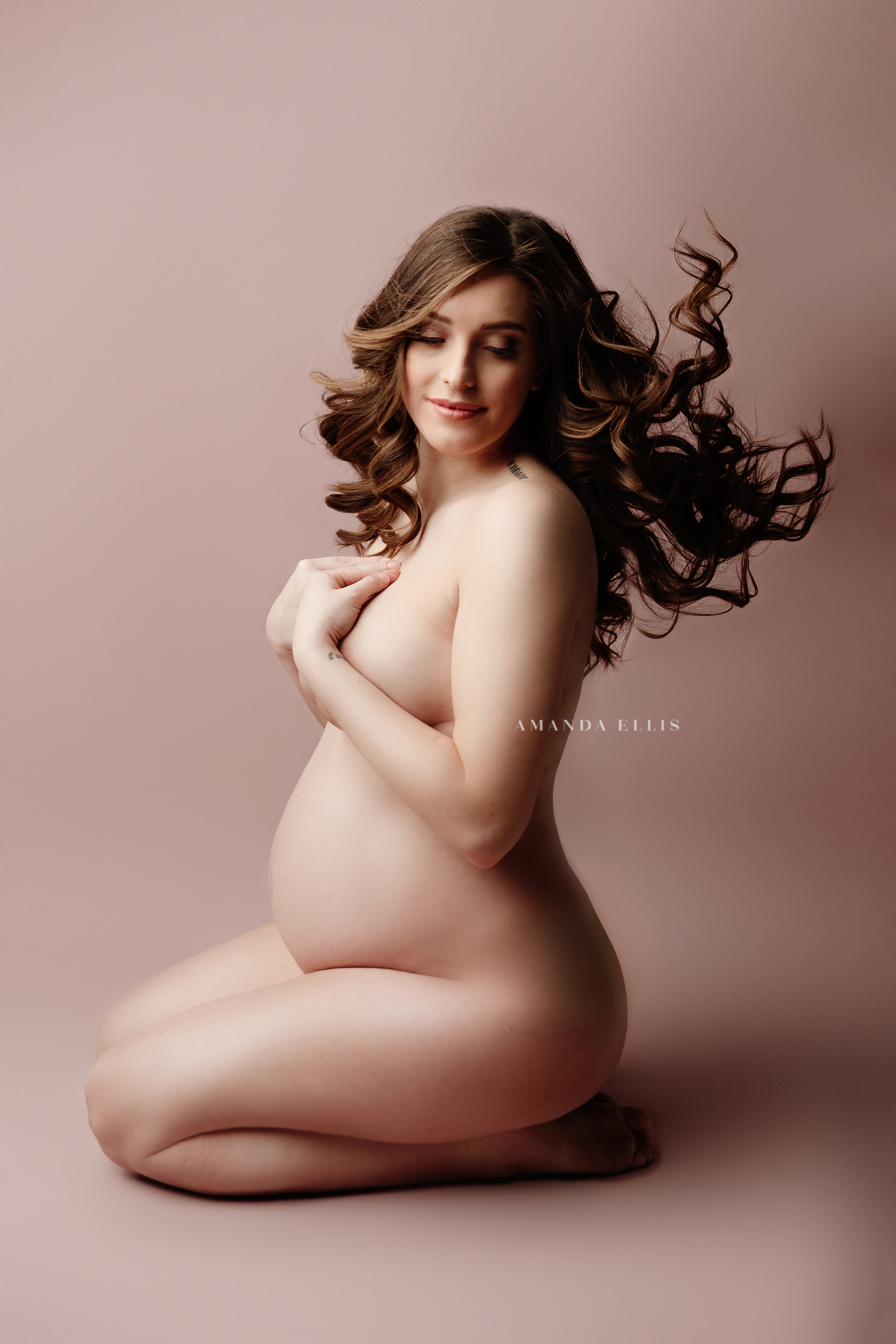 pink background portrait of expecting mother
