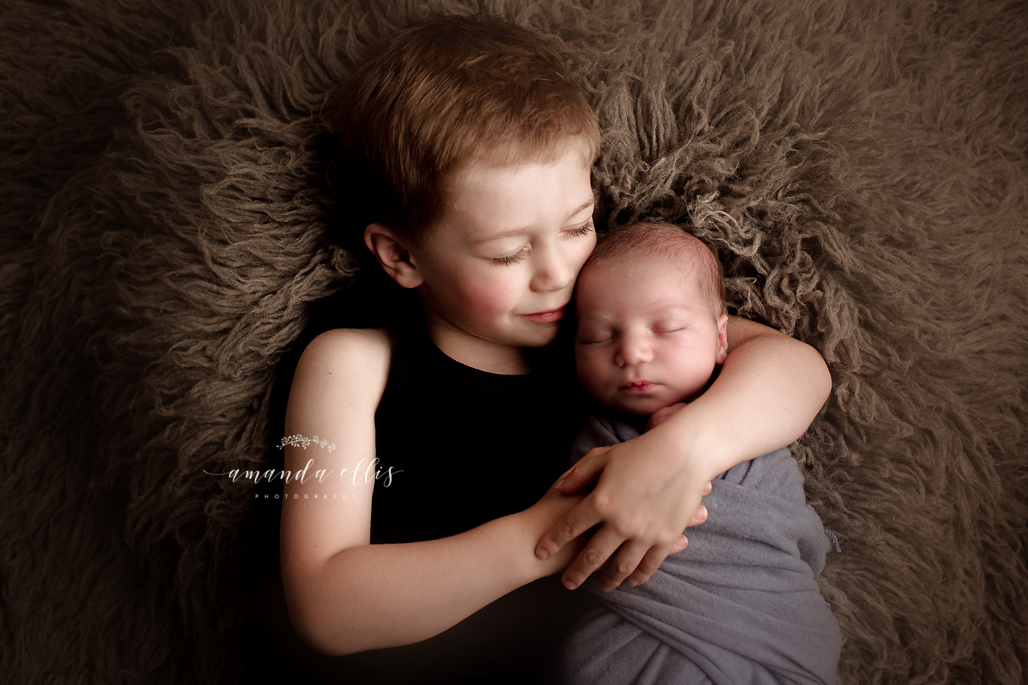 big brother with his newborn brother